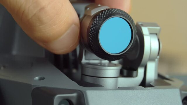 A close-up shot of a hand holding an nd or pl neutral density filter for unmanned cameras, drones, or copters.