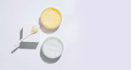 Cosmetics geometry. Body scrub on a white background. View from above. Copy space. Banner