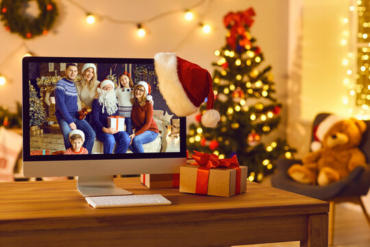 Computer with image of happy family reunited for Christmas set as desktop background