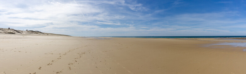 wide empty beach and sand dunes on the Atlantic Ocean coast in France