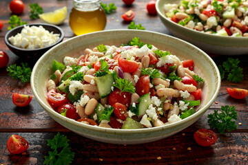 White Bean Salad with Cherry Tomatoes, Cucumber, Red onion, Feta cheese and parsley. Healthy vegetarian, vegan diet food