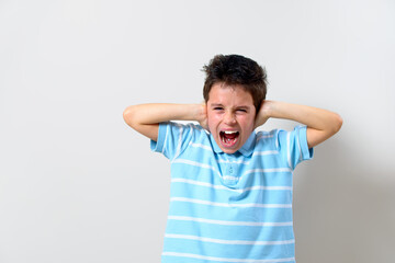 Fototapeta premium The boy in the blue T-shirt covered his hands and shouted.