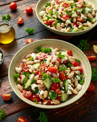 White Bean Salad with Cherry Tomatoes, Cucumber, Red onion, Feta cheese and parsley. Healthy vegetarian, vegan diet food