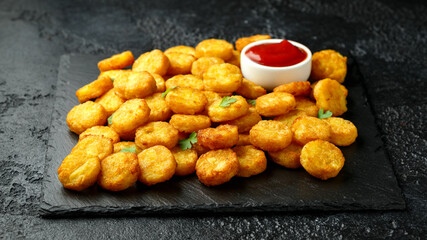 Mini hash browns, tater tots crispy golden potato bites served with jalapeno peppers dipped in ketchup