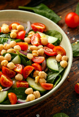 Chickpeas salad with tomato, cucumbers, red onion and greens. Dietary food. Vegan salad.