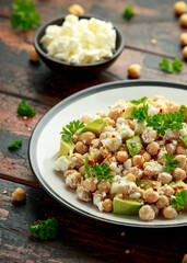 Chickpeas salad with feta cheese, avocado and herbs. healthy food