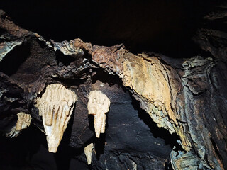 Journey. View inside a deep cave to the south. stalactites and stalagmites.