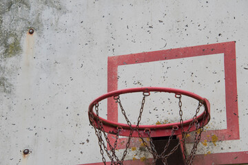 Old damaged basketball shield with chipped paint and board.