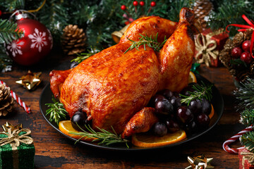 Christmas Chicken, roast in oven with decoration, gifts, green tree branch on wooden rustic table