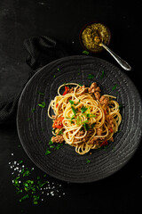 Spaghetti bolognaise with tomatoes, meat and basil on a plate