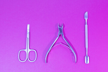 scissors and nail tools on a purple background