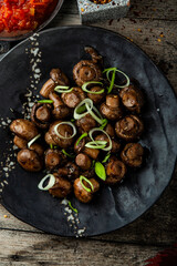 Fried marinated mushrooms with onions and garlic on a plate