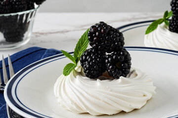 closeup blackberries meringue pavlova with mint