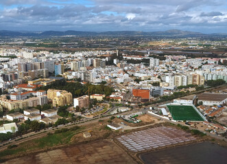 Naklejka premium Aerial view of the city of Faro the beautiful Algarve coast in Portugal seen on a flight to Faro