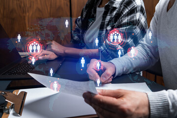 Man and woman working together on international business project. Blue infographic hologram of planet earth. World map. Multiexposure.