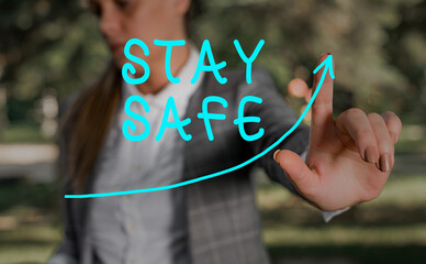 Writing note showing Stay Safe. Business concept for secure from threat of danger, harm or place to...