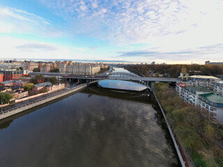 cityscape at sunrise on autumn morning with old houses, highways and river shot from drone