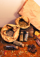 still life of bottles and paper bags with spices and herbs