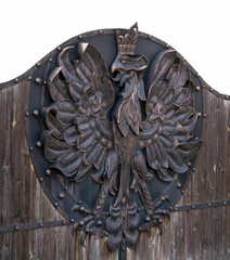 The old forged  gate with the head of the eagle in the middle.
