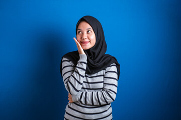 Portrait of Asian muslim student college girl smiling and thinking gesture