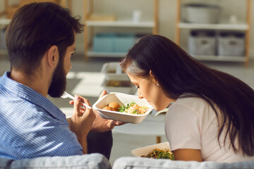 Young couple enjoying fresh healthy takeaway meal they ordered in food delivery service