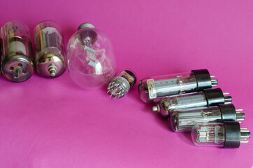 Various vacuum tubes on a pink background