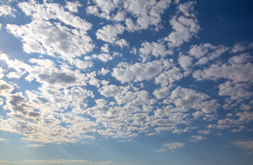 Naklejka na ściany i meble White clouds in the blue sky. Beautiful sky background with clouds.