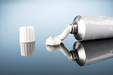 ointment or gel for external use is slightly squeezed out of the tube next to the cap on a gradient...
