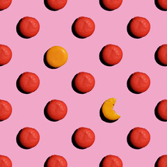 Top view of the cookie pattern round red and two yellow on a pink background