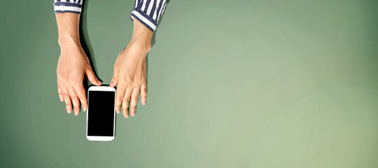 Person using a white smartphone from above © Tierney