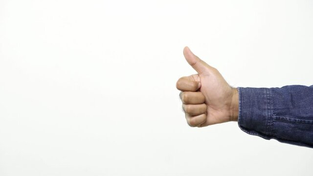 Close up of man&rsquo;s hand pointing to the left side showing thumb up sign isolated on a white background with copy space for place a text, message for advertisement, and promotional. 4K Resolution.