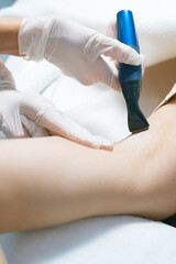 Obraz na płótnie Canvas A woman at salon having a hair removal proceduro on armpits .
