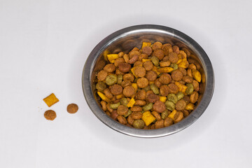 Dry cat food in a metal bowl.