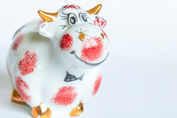 Porcelain figure of a bull, on a white background. New year of the bull