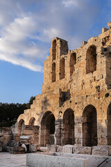 Picturesque view of Greek ruins of Odeon of Herodes Atticus (161AD) - stone Roman theater at the Acropolis hill on sunset. Athens, Greece.