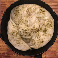 Zaatar bread in cast iron pan ready for baking