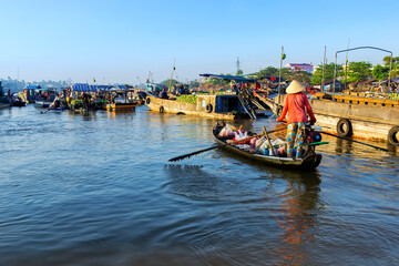 Fototapeta na wymiar Woman rowing boat on the Cai Rang floating market in Can Tho city, Vietnam.