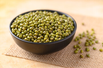 Mung bean in a bowl on wooden background