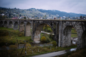 Couple in love standing on the ancients bridge