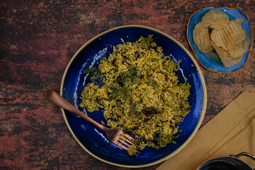 Vegan eggplant rice pilaf in blue clay dish