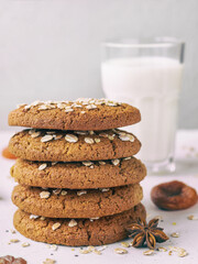 oatmeal cookies and glass of milk on white concrete background