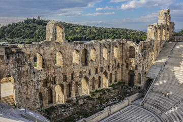 Fototapeta premium Top view of Greek ruins of Odeon of Herodes Atticus (161AD) - stone Roman theater at the Acropolis hill on sunset. Athens, Greece.