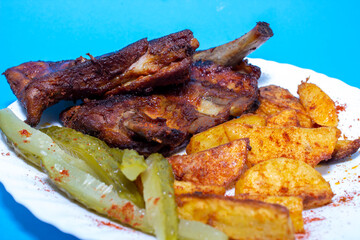 Fried ribs. American honey marinade. blue background