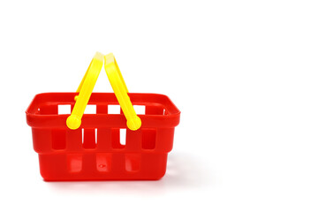 Supermarket toy basket made of red plastic isolated on white background