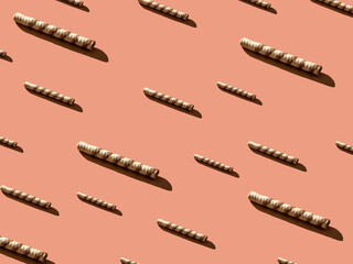 Wafer roll pattern with harsh shadow trends on a cream background. Minimal sweet food concept