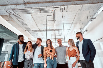Happy diverse professional business team stand in office looking at camera, smiling young staff...