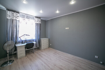 the room in the apartment is in gray. gray wallpaper on wall