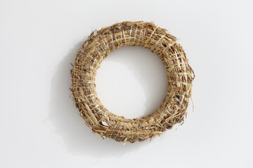 Christmas decorations, top view of hollow straw base for round garland, isolated on white...