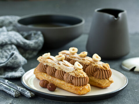 Homemade eclair with chocolate and nuts. Pastry.