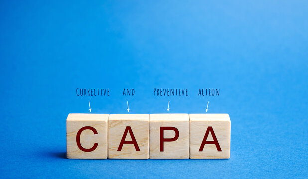 Wooden blocks with the word CAPA. Corrective and Preventive action plans. Business management concept. Strategy and efficiency. Improving organizational processes. Performance